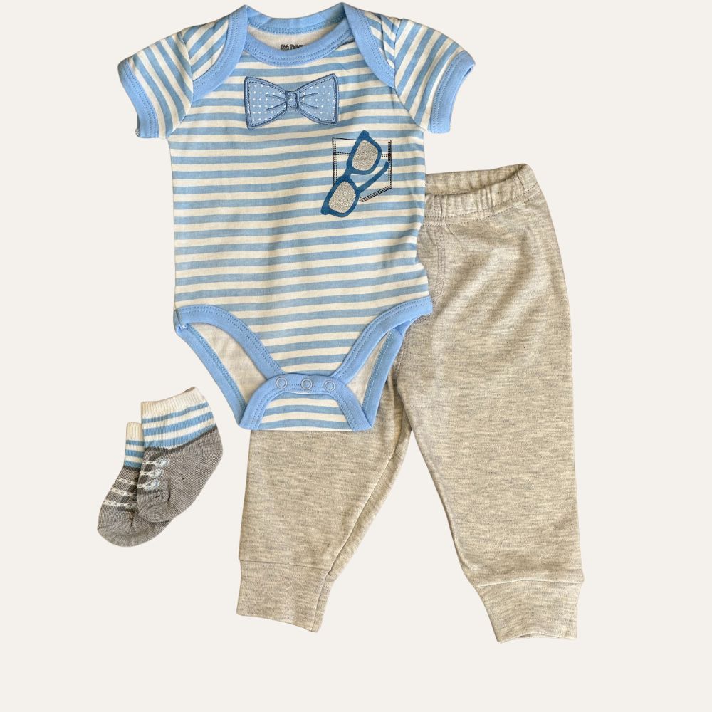 The 3-Piece Baby Boy's Summer Set in Blue & White Stripes by Alaya Junior includes a blue and white striped onesie adorned with a bowtie and glasses design, complemented by light beige pants featuring an elastic waistband, and matching socks. The onesie is detailed with light blue borders and fasteners at the bottom. This set is perfect for newborn baby clothing in Pakistan.