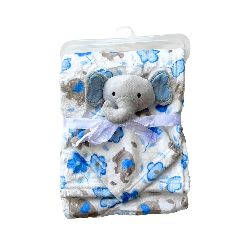 The Soft Baby Blanket with Cute Plush Toy from Alaya Junior is neatly folded and tied with a white ribbon. The soft, white blanket features blue and gray animal patterns. Attached to the top is a plush toy—a gray elephant head with large ears and a friendly expression. The blanket is packaged in a clear plastic hanger.