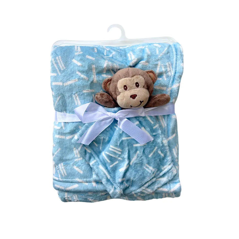 The Alaya Junior Soft Baby Blanket with Cute Plush Toy is a folded blue blanket featuring a white animal pattern, tied with a light blue ribbon. Attached at the center is a small plush monkey toy. The blanket is elegantly presented on a white plastic hanger.