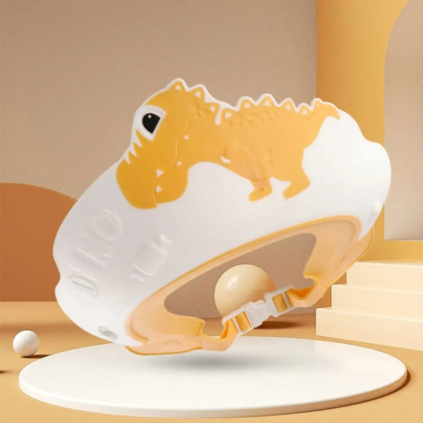 Introducing the Adjustable Dinosaur Baby Shower Cap for Kids from Alaya Junior, showcased in a delightful white and orange dinosaur theme. Crafted with child-friendly materials, this innovative shower cap features a distinct design at its center and is elegantly displayed on a white circular platform. The backdrop is adorned with soft orange and beige tones complemented by geometric shapes.