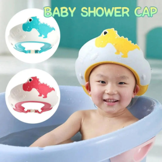 A child in a bathtub sports an Adjustable Dinosaur Baby Shower Cap for Kids from Alaya Junior, featuring a bright yellow design made of child-safe materials. Accompanying the scene are two more caps with red and blue dinosaur motifs, providing bath time protection. The phrase "Adjustable Dinosaur Baby Shower Cap for Kids" headlines the image.
