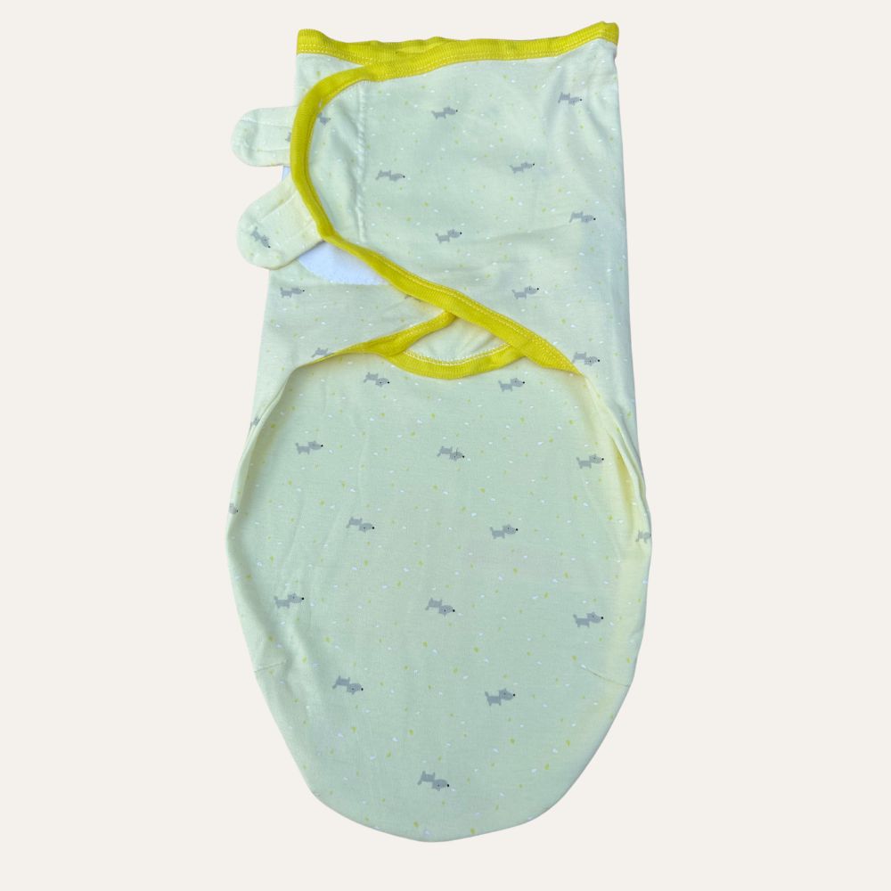Introducing the Alaya Junior Baby Boys Newborn Summer Swaddles, part of our delightful collection. This lightweight swaddle showcases a light yellow fabric adorned with small gray animal silhouettes and features an adjustable closure. A cheerful yellow trim makes it perfect for keeping your little one cozy and content.