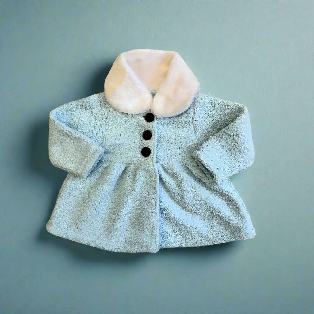The Alaya Junior Baby Girl Sherpa Winter Cardigan, featuring a pastel blue color with a fluffy faux fur collar, three black buttons, and long sleeves, is showcased against a matching light blue background.