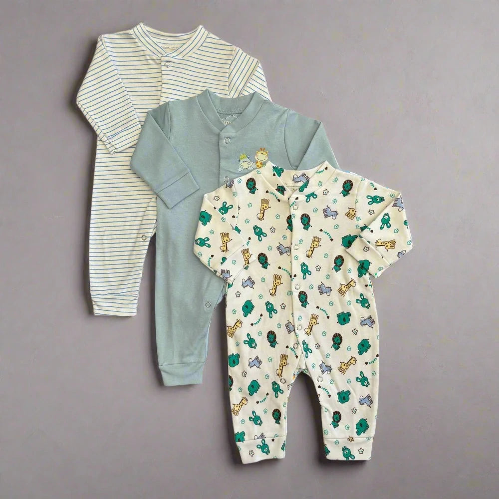 Three open feet rompers from the Summer Carters Pack of 3 by Alaya Junior are laid out on a gray background. The first romper is adorned with white and light gray stripes, the second is a solid light green, and the third showcases a playful animal print featuring giraffes, turtles, and elephants in blue, green, and yellow—perfect for any newborn baby or as infant clothing in Pakistan.