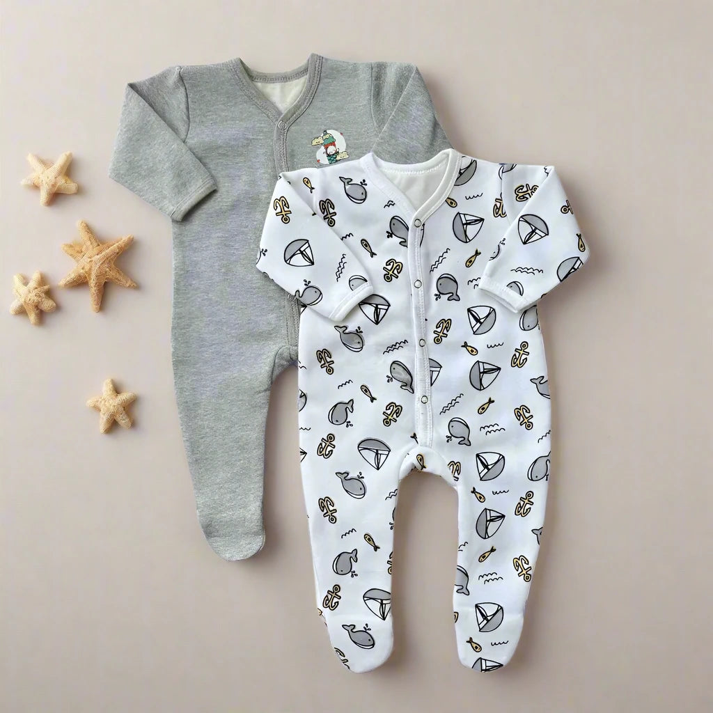 On a beige backdrop embellished with starfish accents lie two cozy baby rompers from Carter's: the Juniors Winter Baby Rompers Pack of 2 (Grey Set). One romper is gray with a small graphic, while the other is white, showcasing playful animal and geometric patterns ideal for chilly days. These designs beautifully blend winter fleece warmth with a nautical charm.