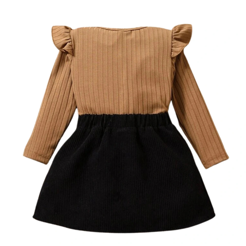The SHEIN Baby Girl Ruffle Trim Tee & Bow Front Skirt features a charming brown ribbed top with ruffled shoulders and a stylish black bottom, making it perfect for any occasion.