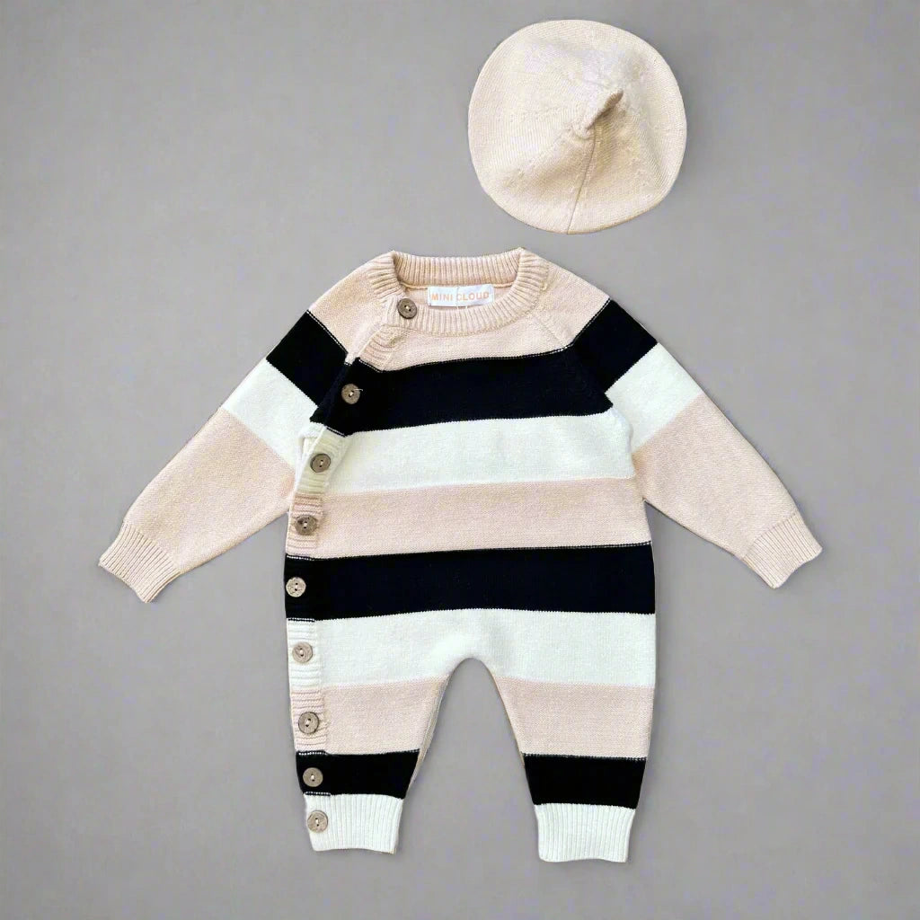 Striped baby romper with buttons and matching hat on a white background