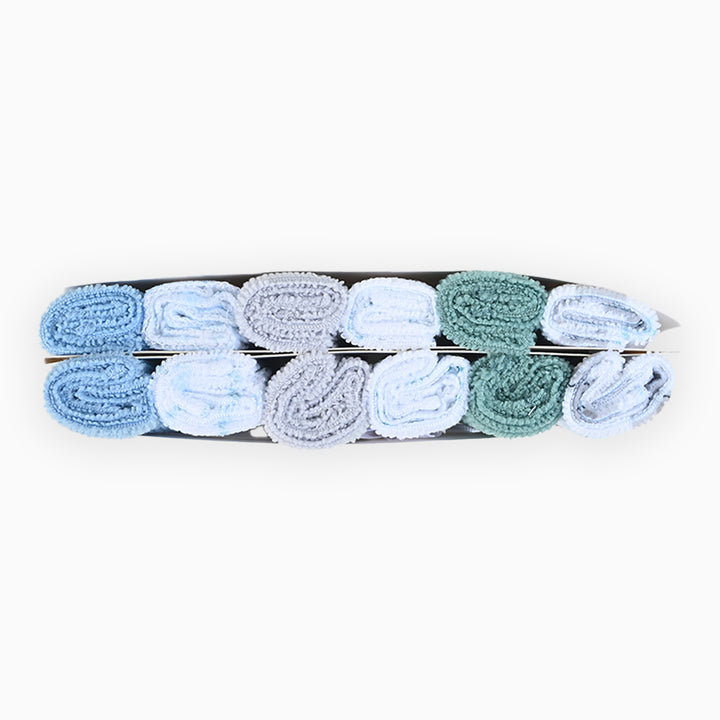 The Alaya Junior Unisex Pack of 12 Imported Towel Gift Set features neatly arranged blue, gray, and green towels, showcasing their soft textures against a plain white background, evoking soothing marine motifs.