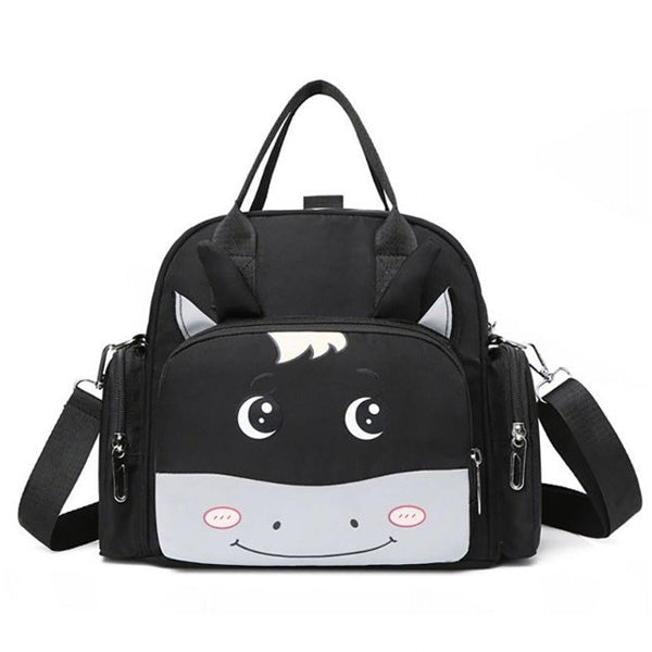 The Luxury Multi-function Mother Backpack Cartoon Waterproof Diaper Bag from Alaya Junior is a stylish black and gray children's backpack designed with a cute, smiling cartoon horse motif. The backpack features two ears protruding from the top, a pair of handles, and a detachable shoulder strap, making it perfect for carrying infant clothing from Pakistan. The front showcases the horse's face with adorable blushing cheeks.