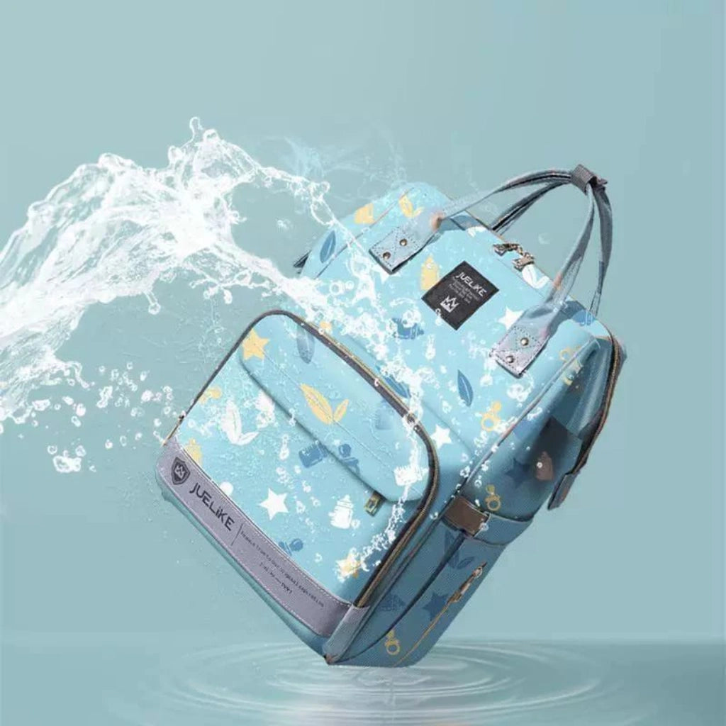 Light blue backpack with star and cloud pattern on a water background