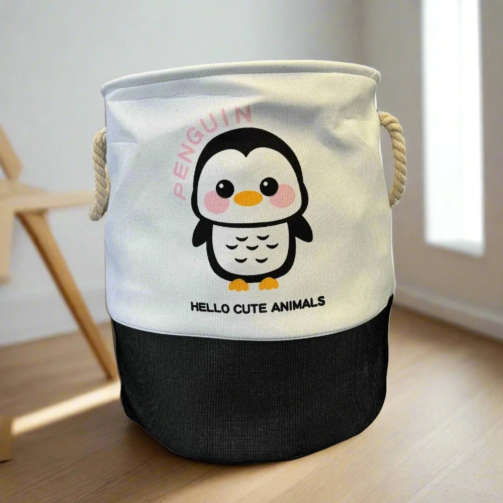 The SHEIN Kids Large Folding Laundry Basket features a foldable fabric design with rope handles and a cartoon penguin graphic. The text reads "PENGUIN" above and "HELLO CUTE ANIMALS" below. Perfect for kids, it adds charm on a wooden floor in a well-lit room.