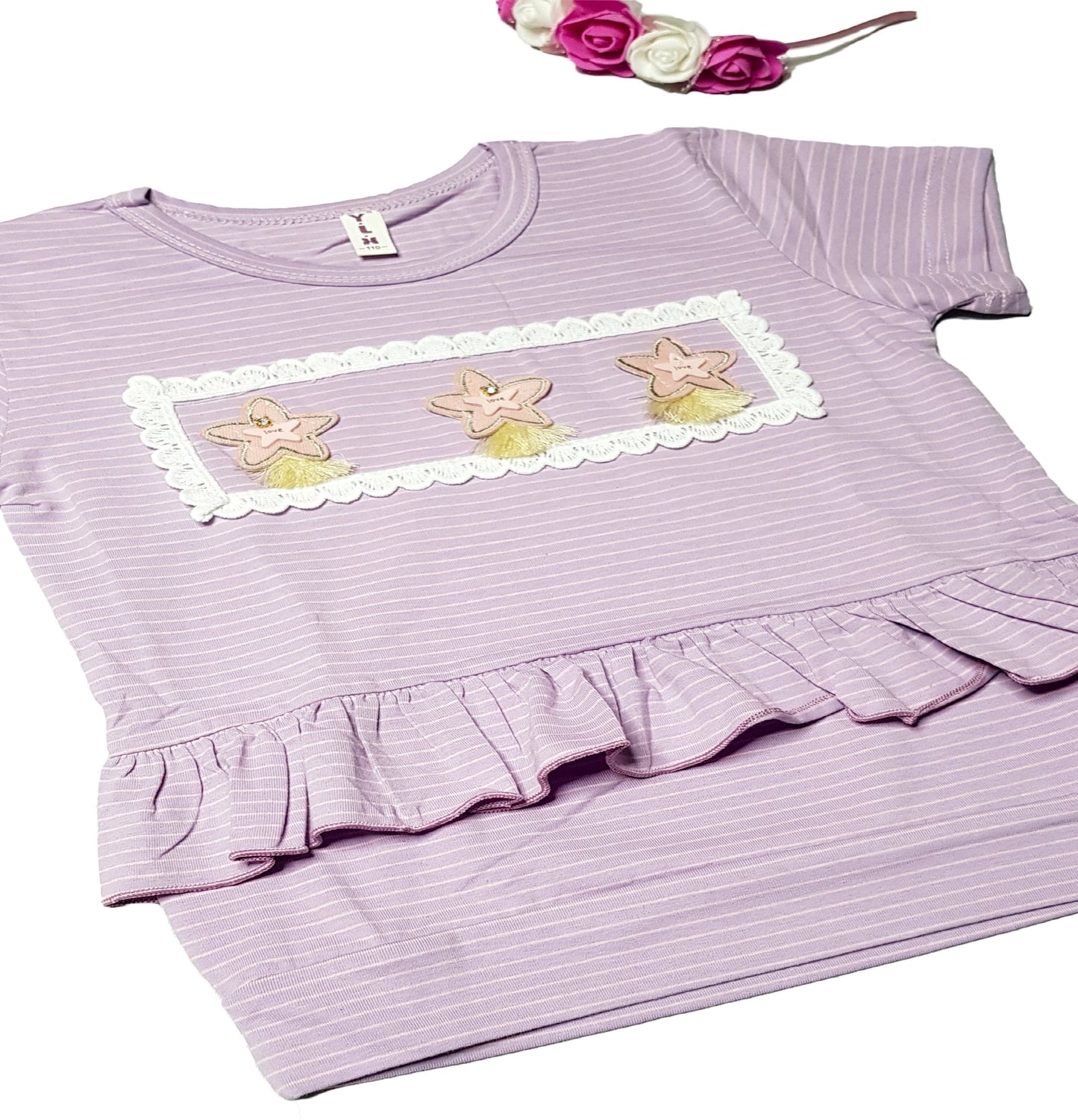 A charming light purple, short-sleeve Baby Girl Top T-shirt by alayajunior features white horizontal stripes, beautifully adorned with three embroidered pink and yellow flowers framed by a white lace border on the chest. The ruffled hem just above the waist adds an extra touch of sweetness, making it a perfect addition to newborn baby outfits and enhancing baby clothing options in Pakistan.