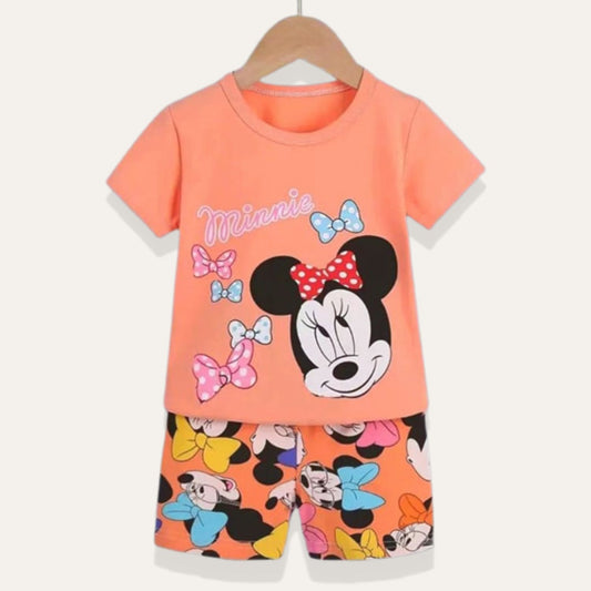 The newborn baby's outfit on a hanger from Alaya Junior features a matching Summer Short and Shirt Set with Minnie's image. The orange T-shirt showcases an illustration of the beloved cartoon mouse, Minnie, adorned with bows and her name. The accompanying shorts echo this theme with multiple images of Minnie and vibrant bows, making it an ideal choice for baby clothing in Pakistan.