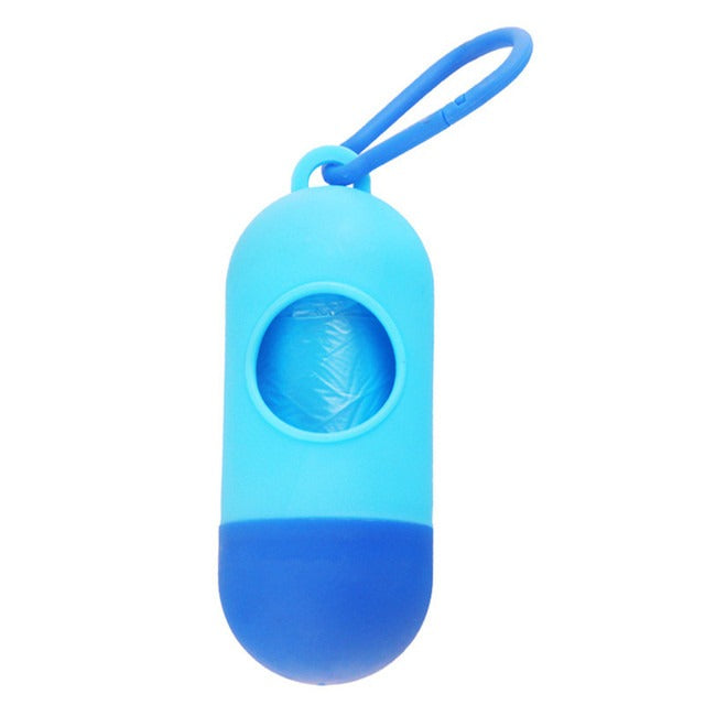 The Alaya Junior Diaper Waste Bags with Dispenser include four rolls of disposable blue bags in a biodegradable, odor-resistant capsule holder, featuring a clip for easy carrying. The capsule shape and round window display the roll inside.