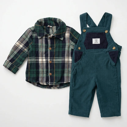 A two-piece baby outfit set featuring a green and navy plaid long-sleeve shirt with gold buttons, paired with dark teal corduroy overalls with navy pockets and gold snap buttons, laid flat on a white background.