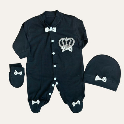 Discover adorable elegance with Alaya Junior's Charming Trio: MJ Baby Bow Romper Set. This black onesie, adorned with white polka dot bows and a crown design, includes matching mittens and a hat, each detailed with cute bows. Comfort meets fashion with front white buttons.