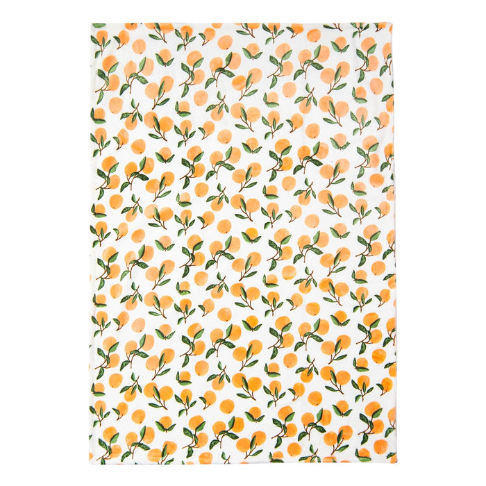 A Luvable Friends' Citrus Bliss: Unisex Sherpa-Backed Plush Blanket from Alaya Junior, featuring a white background with a repeated pattern of oranges and green leaves. The fruits are scattered evenly across the blanket, giving it a fresh and vibrant appearance, reminiscent of the playful designs often seen in newborn baby clothing in Pakistan.