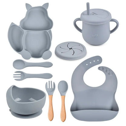 Collection of gray baby feeding utensils and accessories on a white background