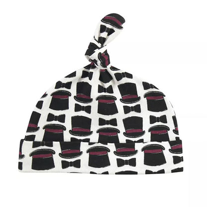 The Hudson Baby Infant Boy Cotton Cap Set by Alaya Junior, called "Vintage Little Man," is a baby essential for newborns aged 0-6 months. Crafted from super soft cotton, it showcases a delightful pattern of black top hats and bow ties accented with subtle red highlights and is completed with a small top knot.