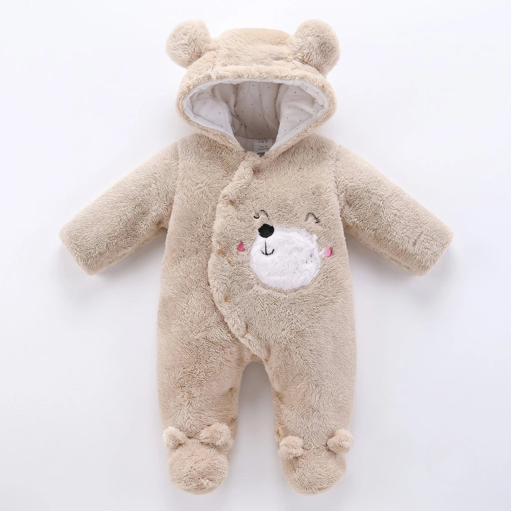 A baby plush hooded one-piece outfit in light beige, designed to look like a teddy bear with a white embroidered face on the front, photographed on a clean white background.