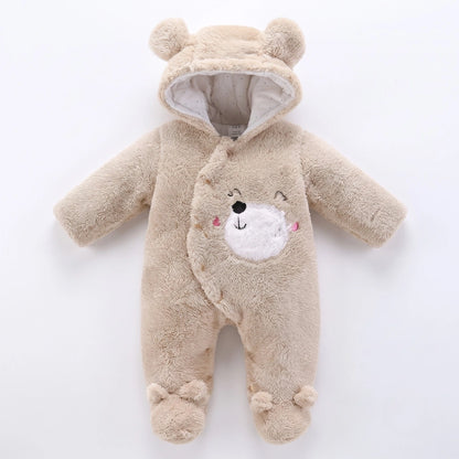 A baby plush hooded one-piece outfit in light beige, designed to look like a teddy bear with a white embroidered face on the front, photographed on a clean white background.