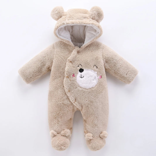 A baby plush hooded one-piece outfit in light beige, designed to look like a teddy bear with a white embroidered face on the front, photographed on a clean white background.