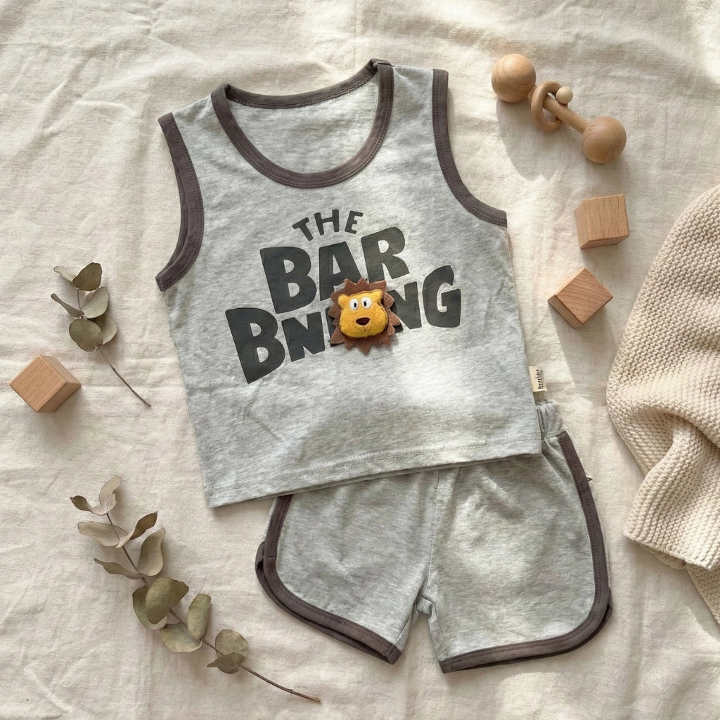 Children's sleeveless top and shorts set with 'The Bar B Que' text and lion graphic on a light background.