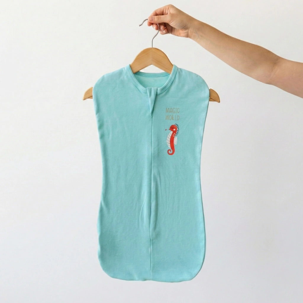 Light blue sleeveless garment with a seahorse design on a hanger against a white background