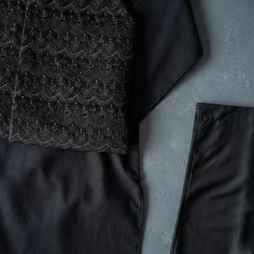 Dark textured fabric with a geometric pattern on a gray surface