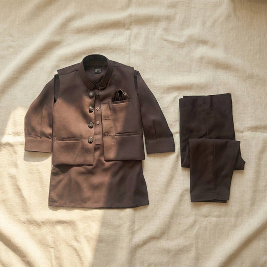 Brown suit jacket and pants on a beige fabric background