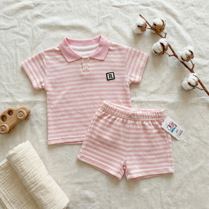 Pink striped children's outfit with a logo on a light background