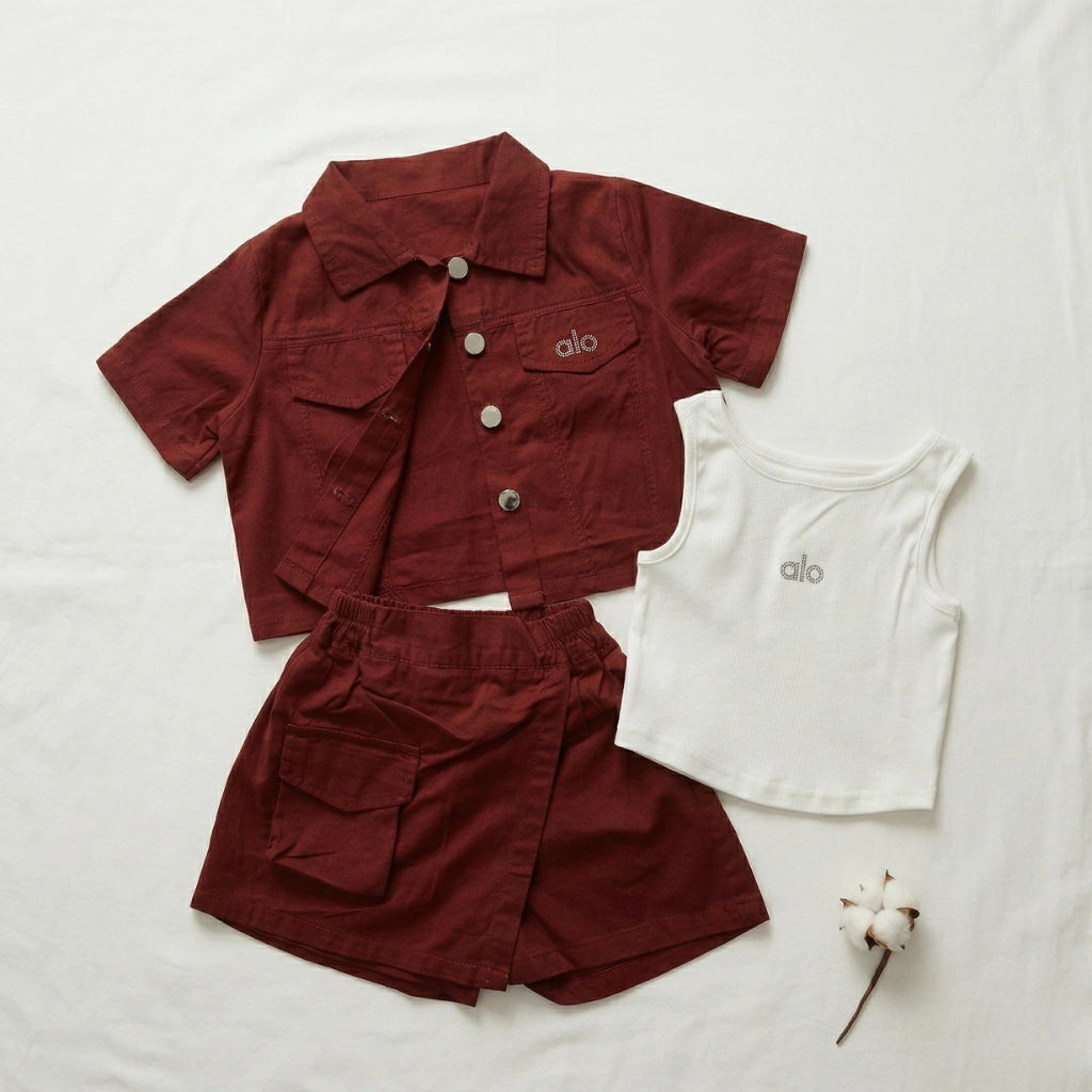 Maroon jacket and shorts with a white tank top on a light background