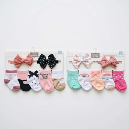Set of baby socks with decorative bows on a white background