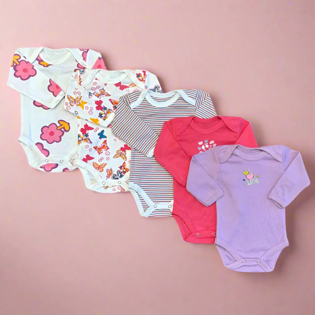 Five Carter's Baby Girl Full Sleeves Bodysuits made of soft cotton are displayed on a pink background. The designs, from left to right, include: white with pink flower print, white with multicolored shapes, beige with brown stripes, red with a small white flower design, and purple with a small bird image. Each features convenient snap-button closures.