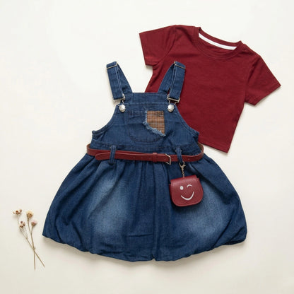 Blue denim dress with red belt and matching purse, and red t-shirt on a light beige background.