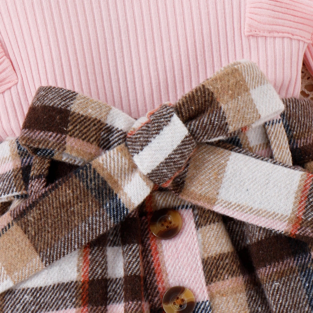 Plaid fabric with buttons on a pink background