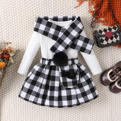 Black ---- Black and white checkered outfit with scarf and shoes on a textured surface