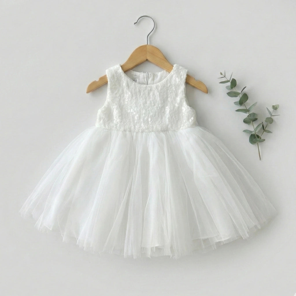 White dress on a wooden hanger with a light gray background