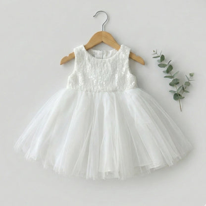 White dress on a wooden hanger with a light gray background