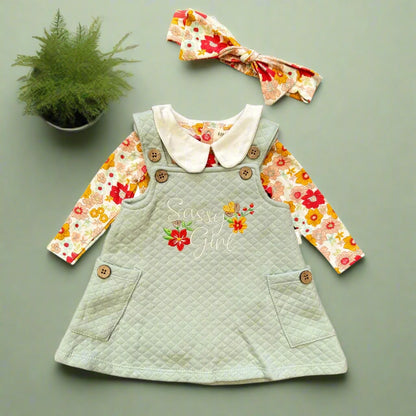 Children's outfit with green dress, floral shirt, and headband on a white background