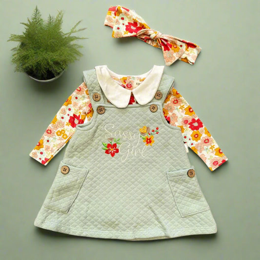 Children's outfit with green dress, floral shirt, and headband on a white background