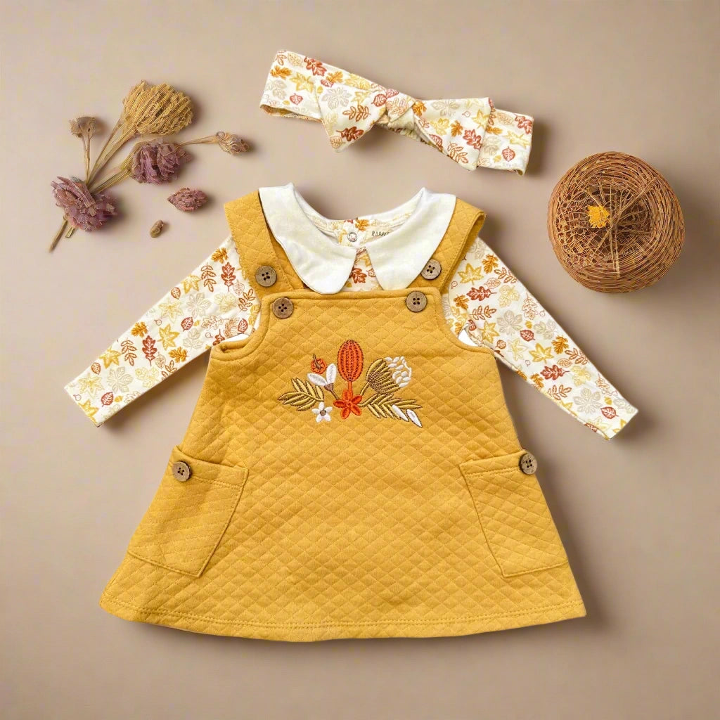 Yellow dress with floral sleeves and headband on a white background