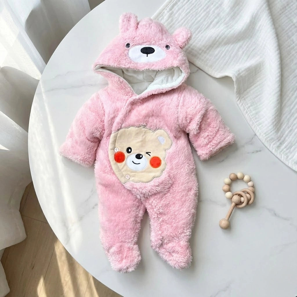 Pink baby snowsuit with bear design on a white background