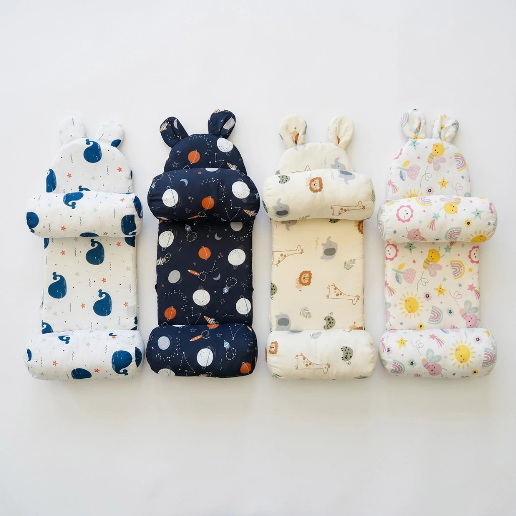 Set of three baby pillows with colorful patterns on a white background