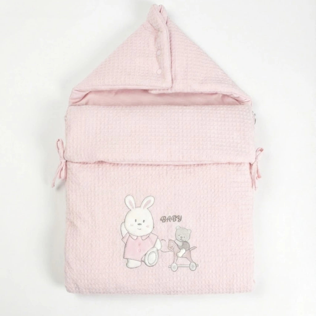 Pink baby sleeping bag with cartoon characters on a white background