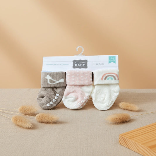 Three pairs of Hudson Baby socks on a white background