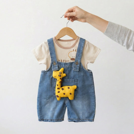 Children's denim overalls with a yellow plush toy on a hanger against a white background