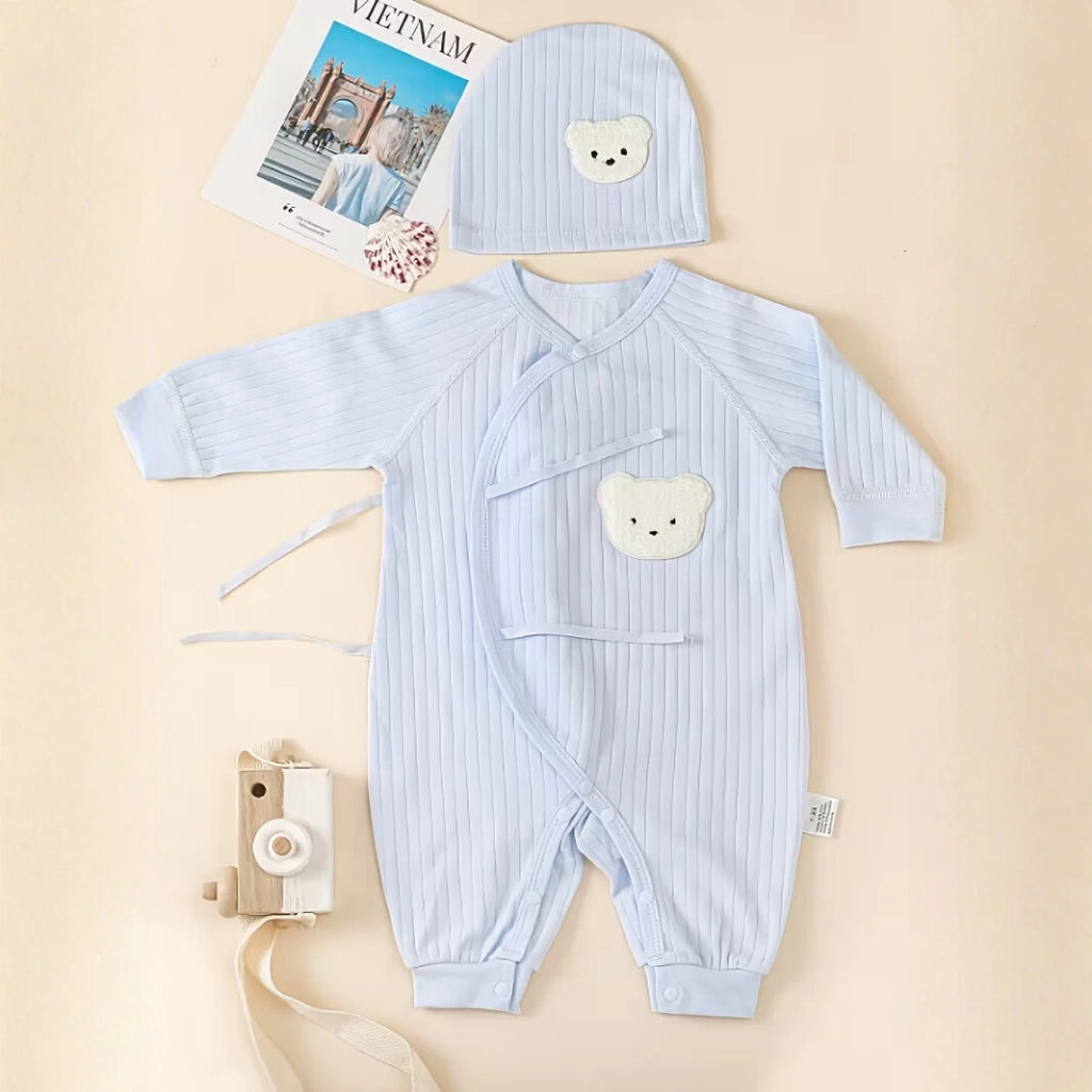 Sky Blue -baby romper with bear design and matching hat on a beige background