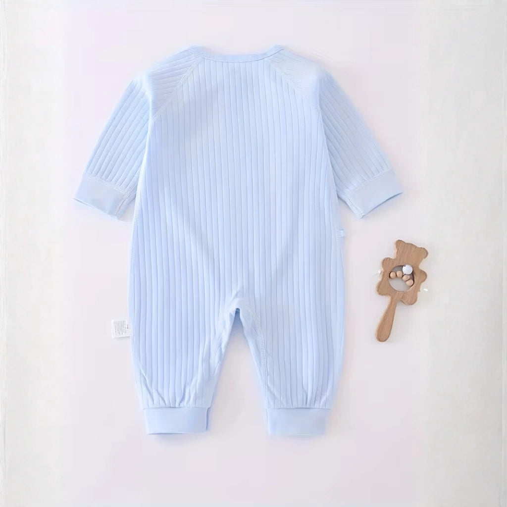 Sky Blue - Light blue baby romper on a white background with a wooden rattle.