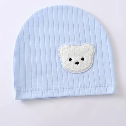 Sky Blue - Light blue baby hat with a white teddy bear patch on a light gray background